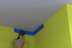 photo masking a ceiling with tape at a wall corner