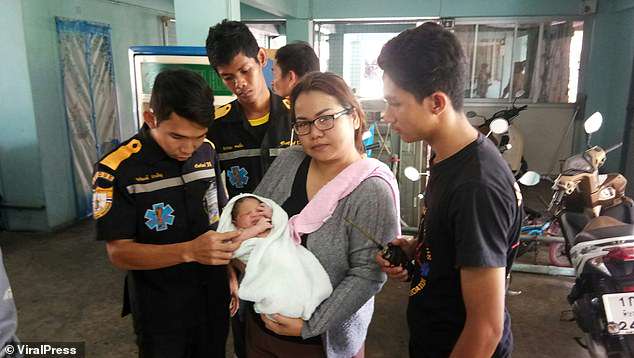 The baby (in the arms of a carer) was surrounded by thick broken leaves, which cushioned his fall from the room, high above