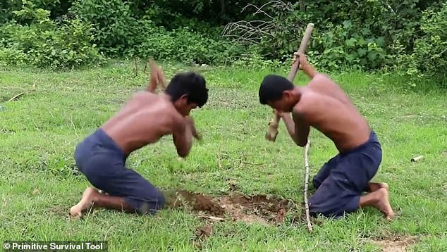 The two men from Cambodia start by digging a hole in the ground using only rudimentary tools