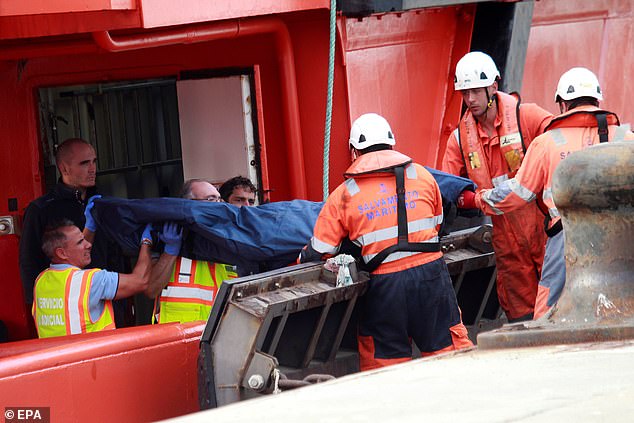 Sea Rescue members on October 11 carrying the body of a 75-year-old woman who fell from the deck of the Costa Pacifica cruise ship while in the Strait of Gibraltar the previous day