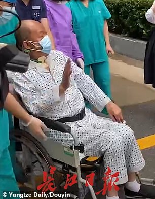 Footage released by Chinese media shows a mask-donning Mr Cui waving to well-wishers while being wheeled out of the hospital in Wuhan, China, on Tuesday
