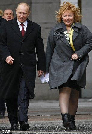 Russian Prime Minister and presidential candidate Vladimir Putin, left, and his wife Lyudmila Putin arrive at a polling station in Moscow, Russia, Sunday, March 4, 2012