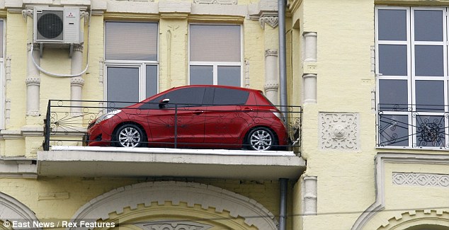 Car-azy: The vehicle is 80ft up but no-one knows how it got there. There