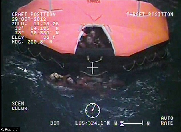 Emergency: This image shows a crewman from the replica tall ship HMS Bounty being aided in the water by a member of the U.S. Coast Guard