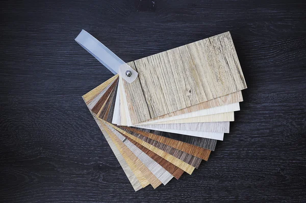 Laminate wood texture floor :oak tile, maple tile, chestnut tile, walnut tile, balsam tile,   Samples of laminate and vinyl floor tile on wooden Background. Laminate use in the house, Hospital, Townhouse, Condominium, Hotel, Apartment, Department Royalty Free Stock Photos