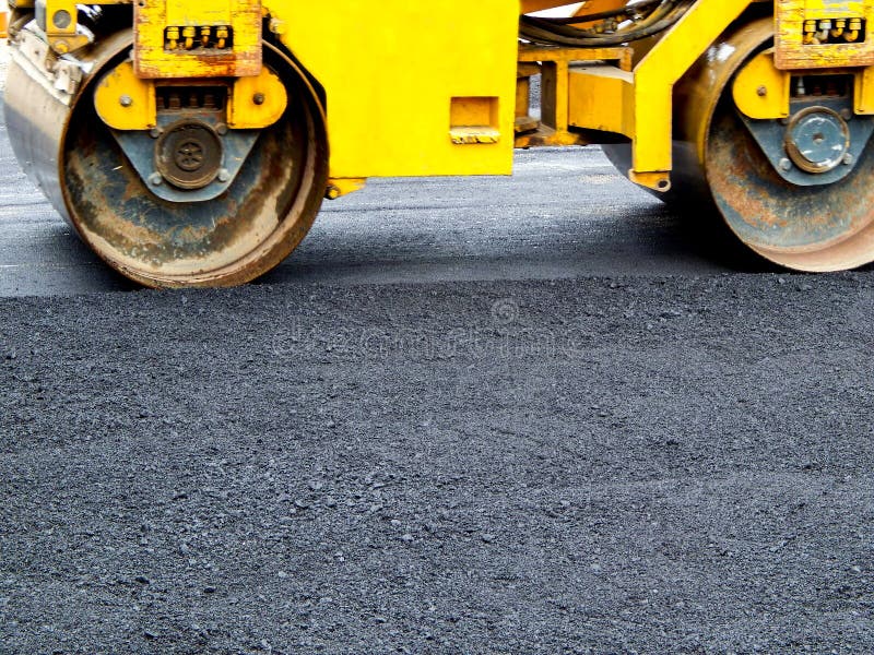 Paver Road construction, asphalt concrete pavementpaver Road construction, asphalt concrete pavement during the sunny day stock images