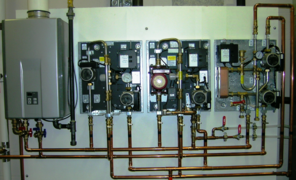 Modern factory assembled hydronic control appliances for underfloor heating and cooling, shown with covers off 