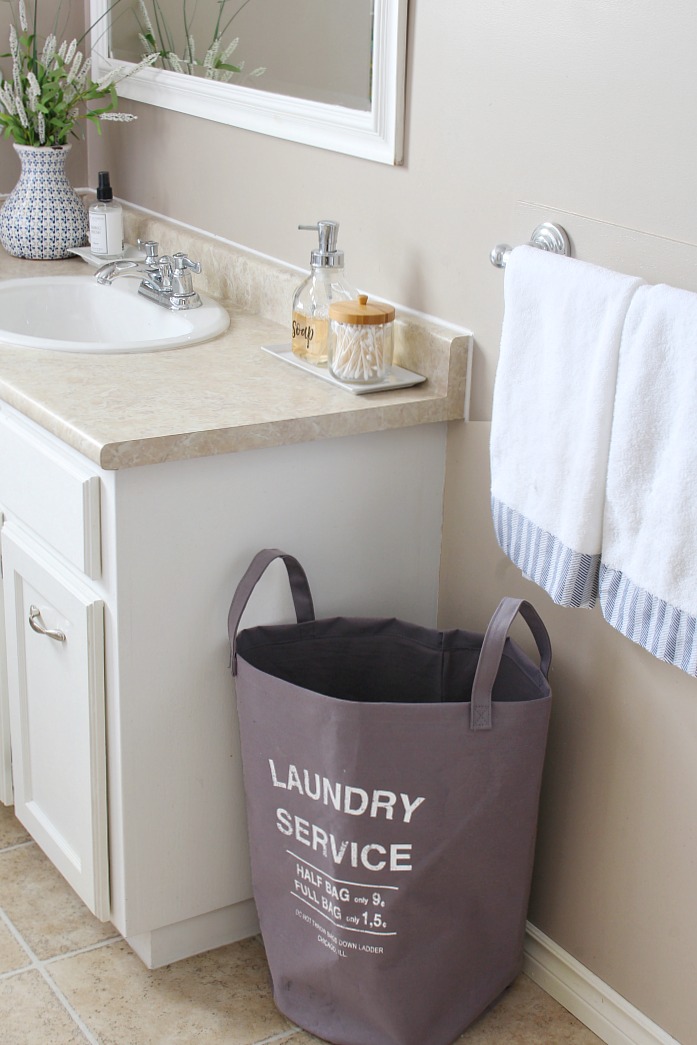 Organized bathroom cabinet with labeled storage.