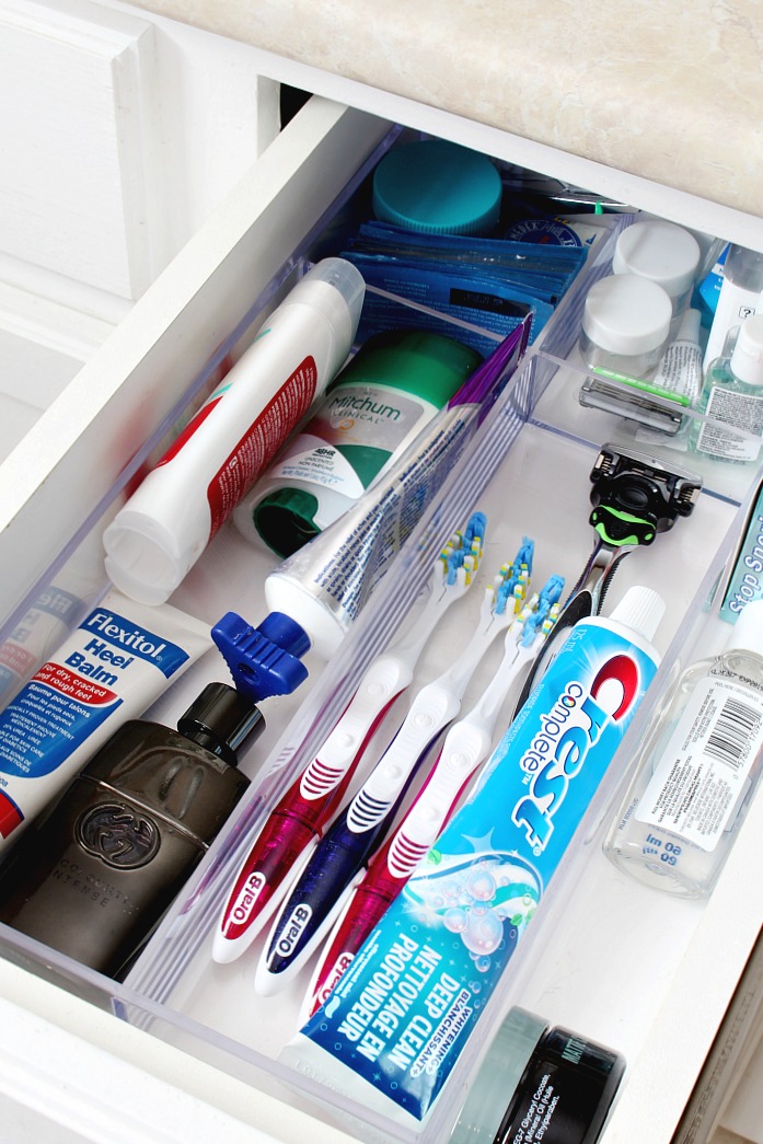 Organized bathroom drawer using an acrylic drawer divider tray.