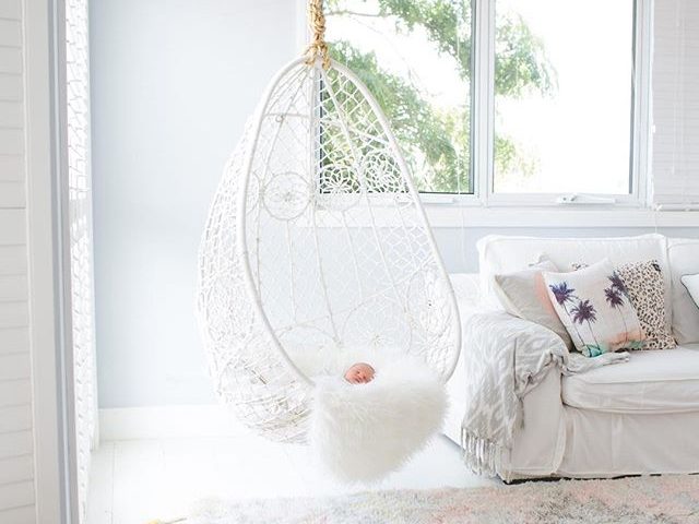 Hanging Basket Chair in White For Living Room with a baby