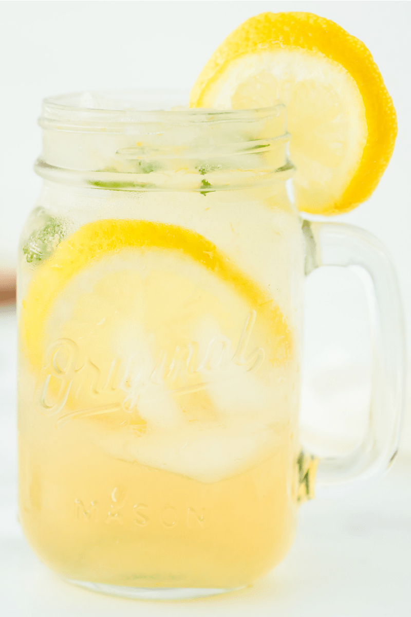 vodka lemonade in a jar mug garnished with lemon