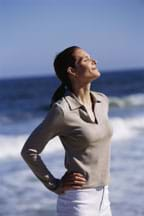 Photo shows a woman with eyes closed, facing the warm sun